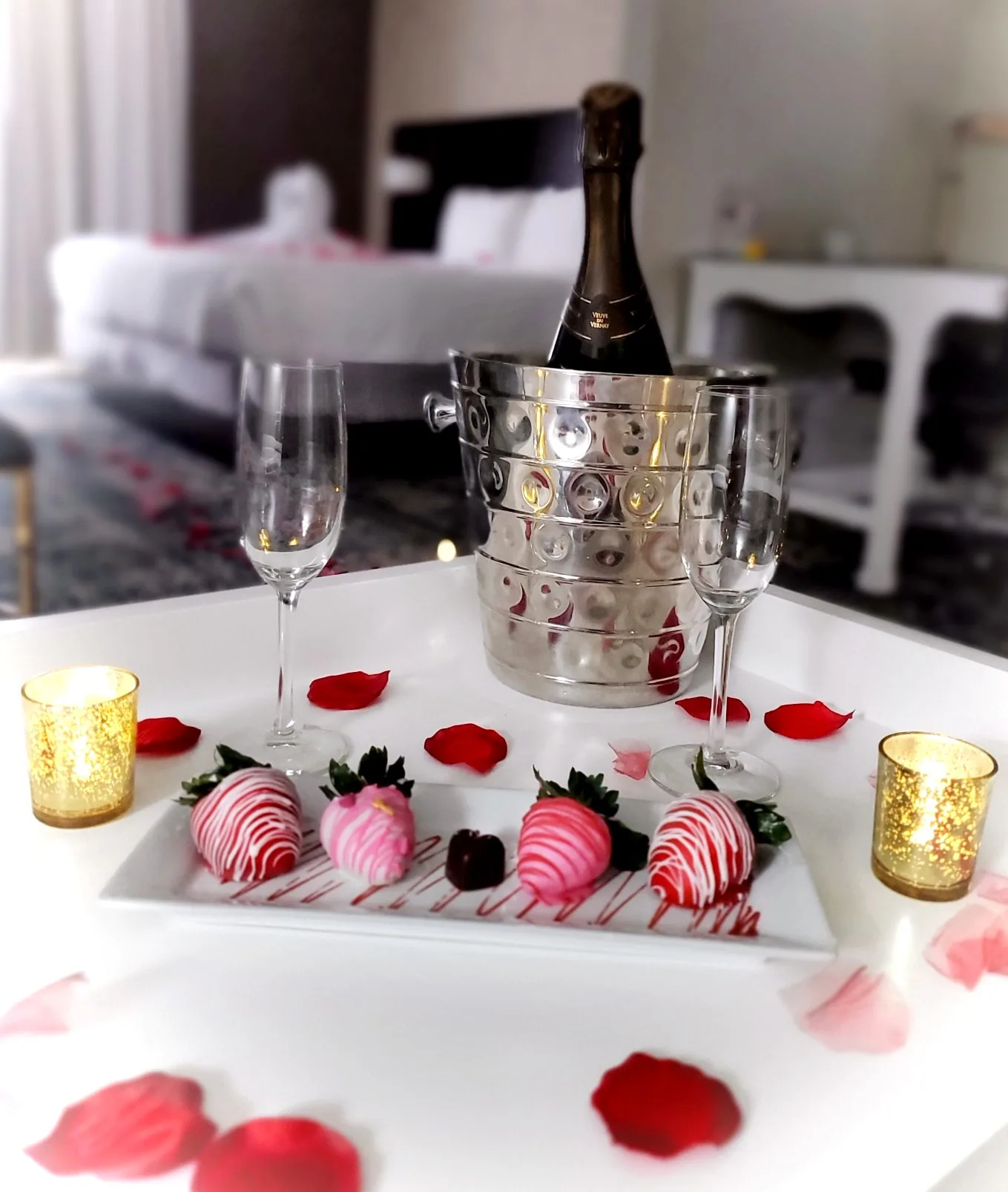 Champagne with chocolate-covered strawberries in a guest room