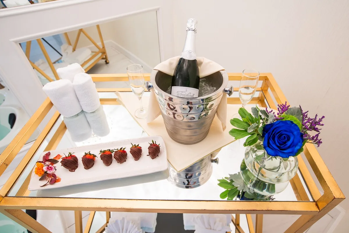Champagne, strawberries and flowers prepared in a guest room