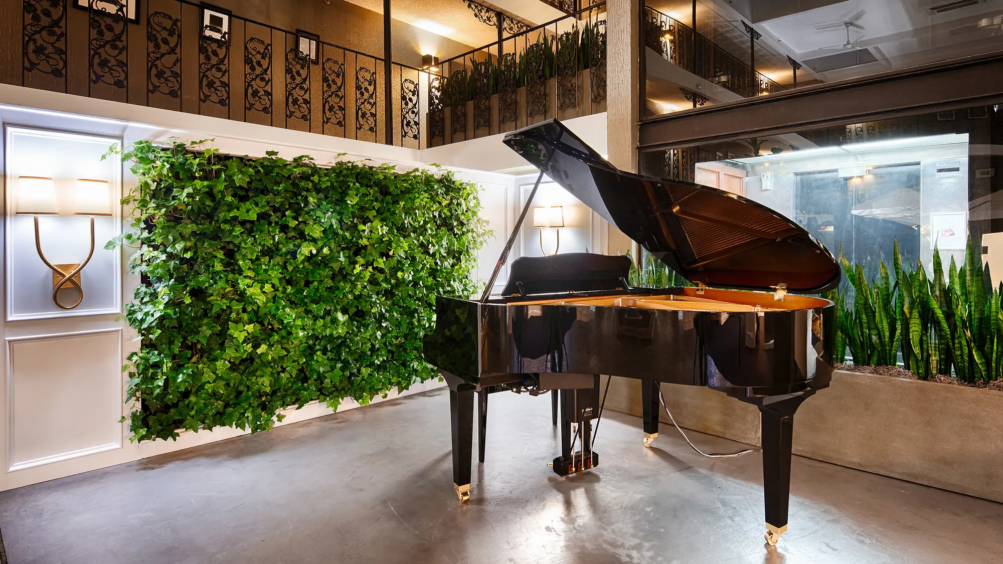 Grand piano and living wall in The Burgundy atrium